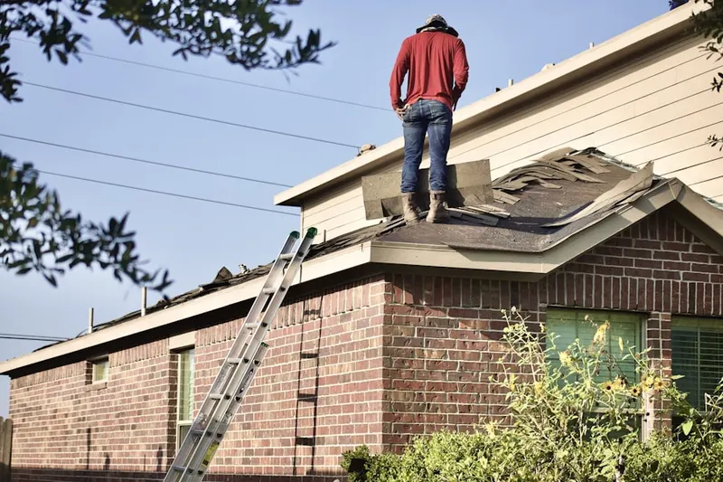 Professional roofer working on a residential roof in Rockville Centre